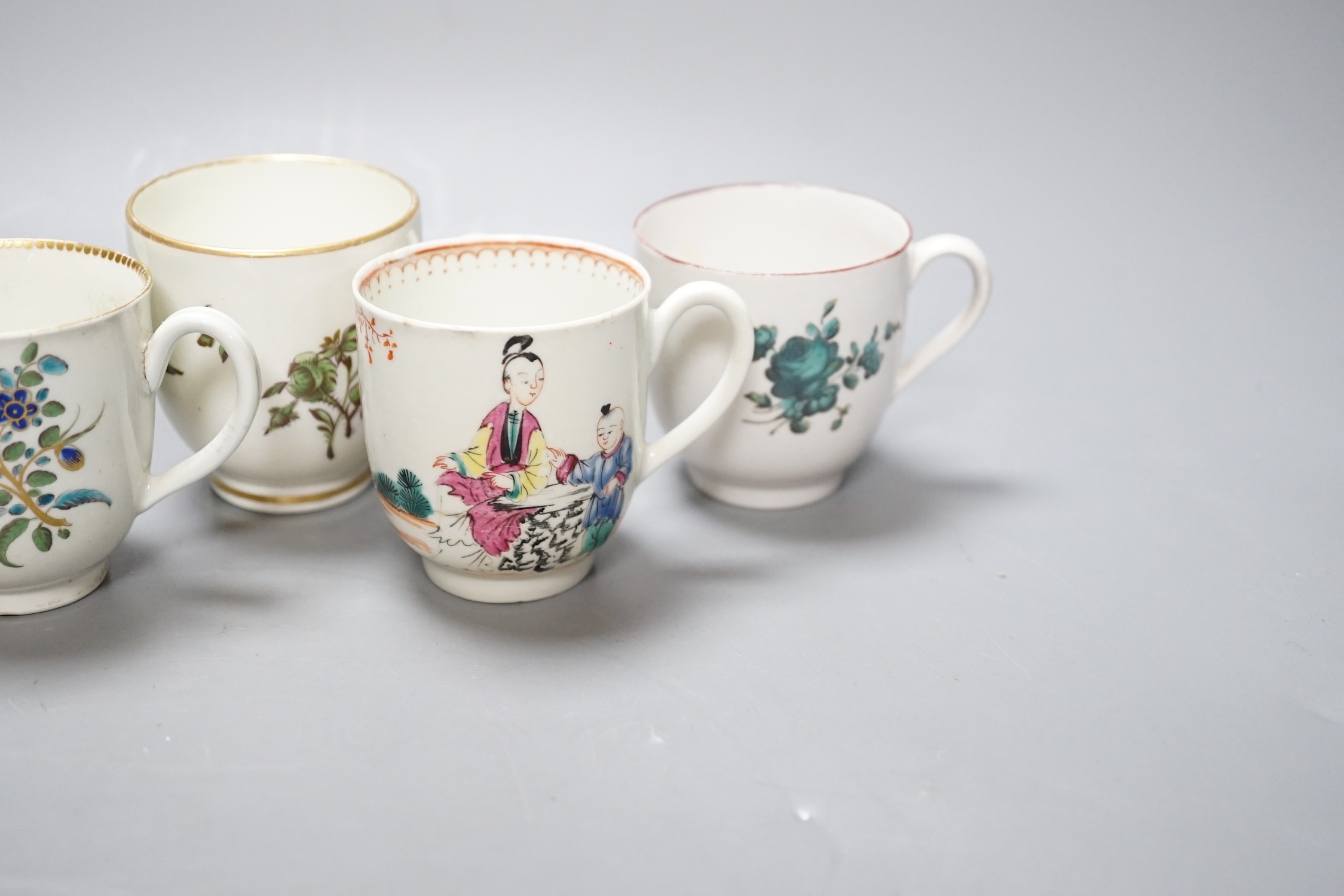 A Worcester coffee cup with oriental figures, another with flowers in green blue and gold, two Chelsea Derby coffee cups and two Christian Liverpool tea bowl with roses, largest bowl 9 cms diameter
